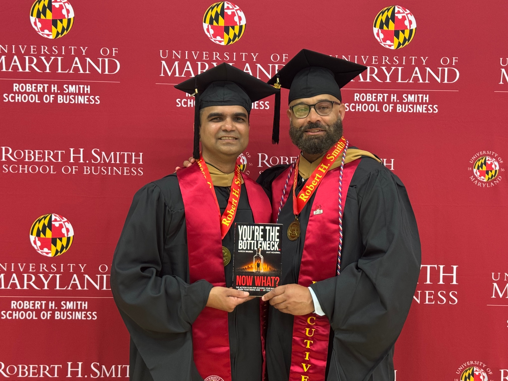 Aaron Warren and Lalit Agarwal holding You're the Bottleneck. Now What? at the University of Maryland Robert H. Smith School of Business.